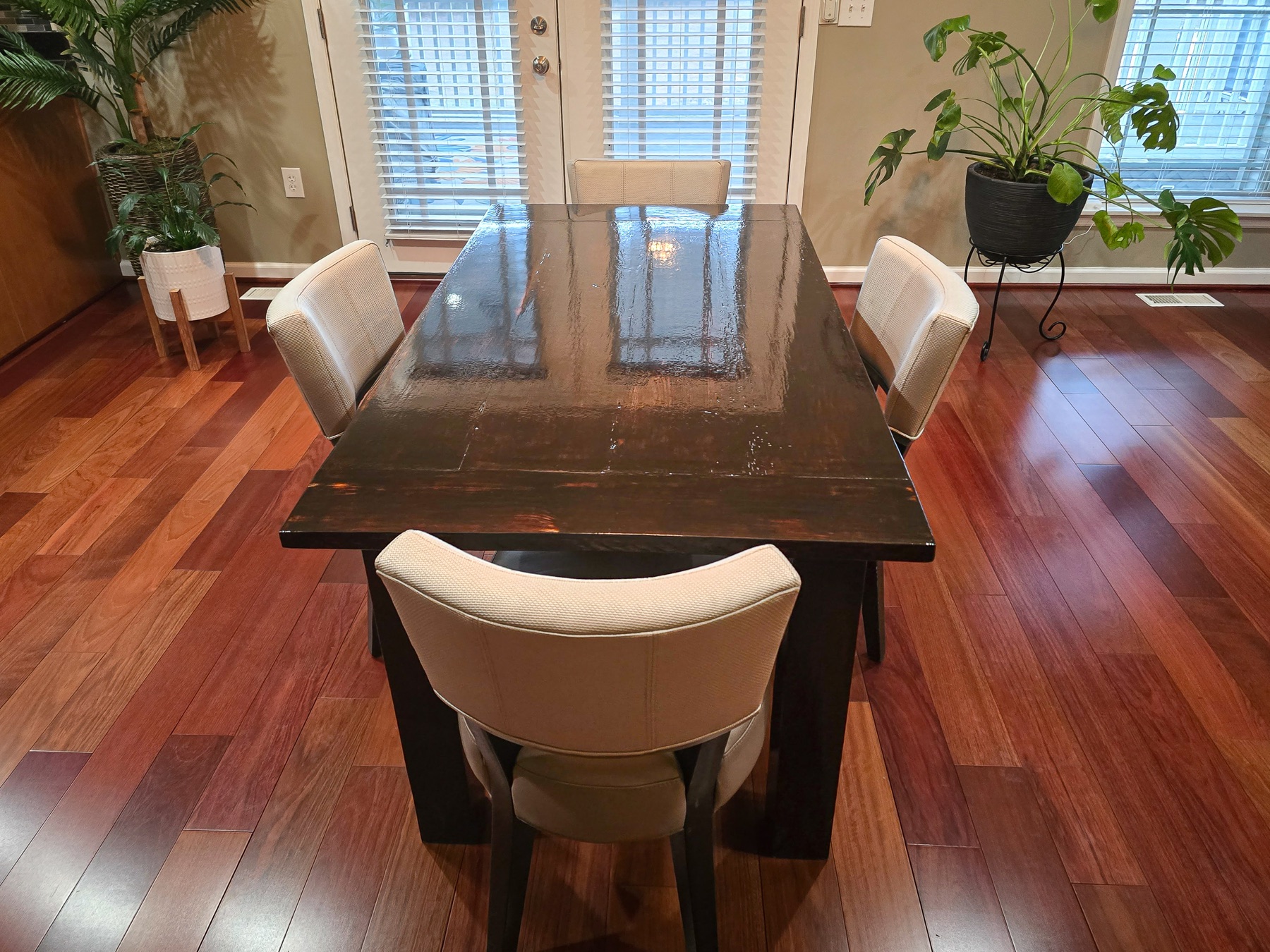 Finished dark-stained farmhouse table with upholstered dining chairs